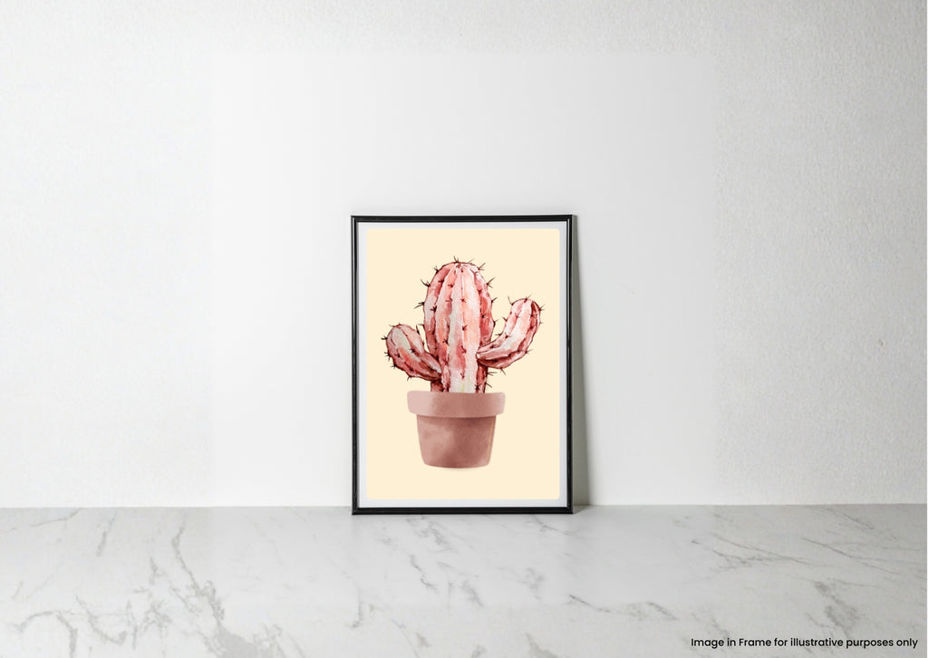 A framed art print featuring a watercolor-style pink cactus in a terracotta pot, leaning against a white wall on a light marble surface.