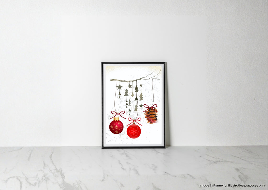 A framed art print featuring a watercolor illustration of red Christmas ornaments and pinecones hanging from a branch, displayed on a light marble surface against a white wall.
