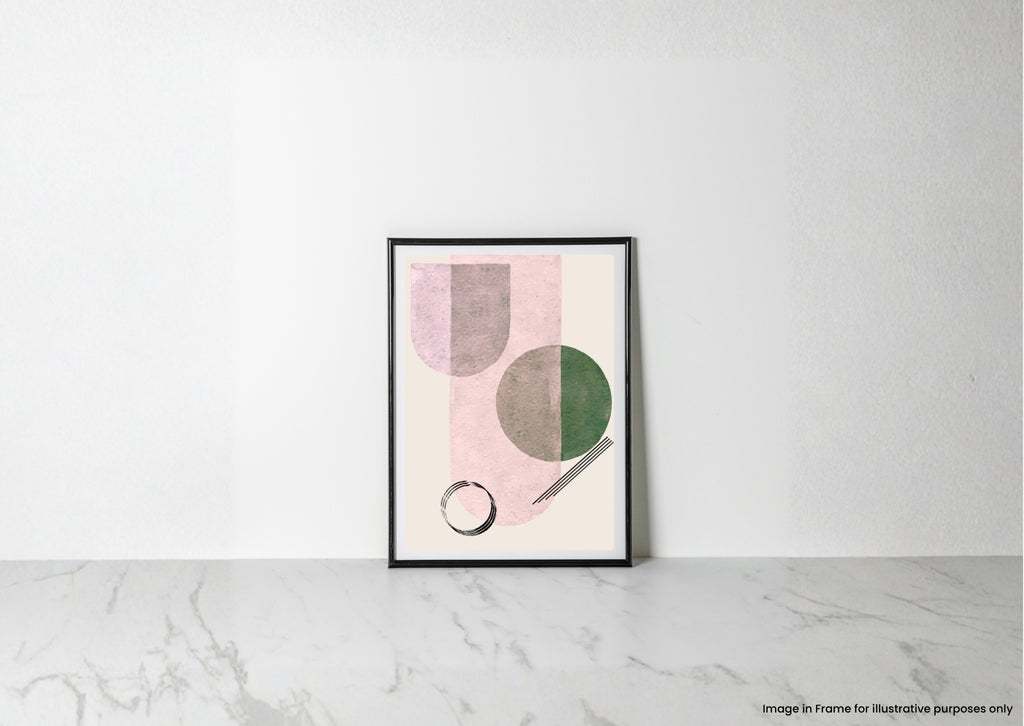 A framed abstract art print with pink, green, and gray geometric shapes, leaning against a white wall on a light marble surface.