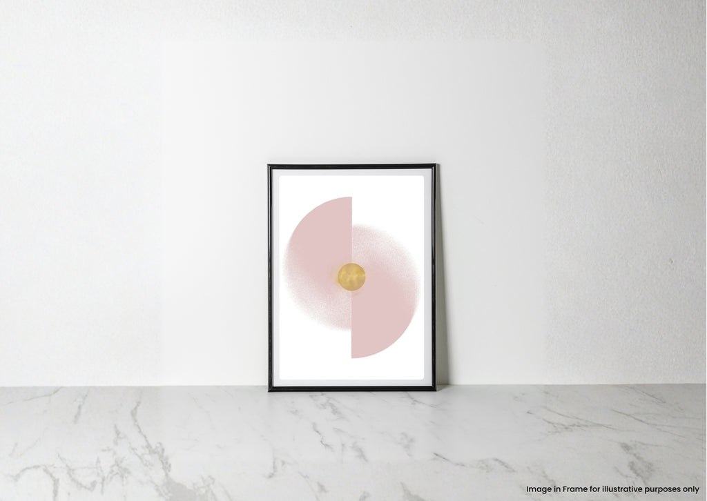 A minimalist framed art print with a black frame, featuring a pink half-circle and a gold central dot on a white background, leaning against a white wall on a light marble surface.