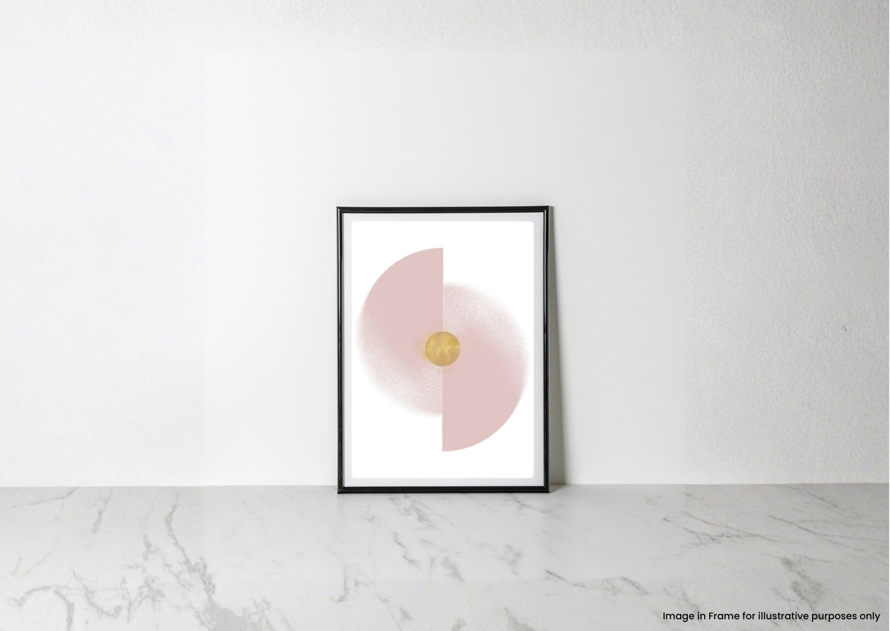 A minimalist framed art print with a black frame, featuring a pink half-circle and a gold central dot on a white background, leaning against a white wall on a light marble surface.