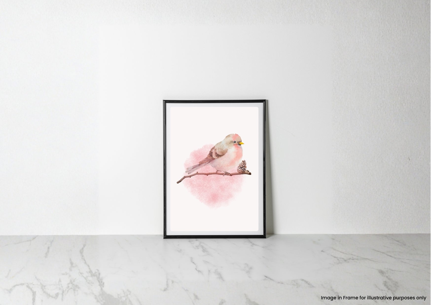 A framed watercolor art print of a small pink bird perched on a branch, displayed against a white wall on a light marble surface.