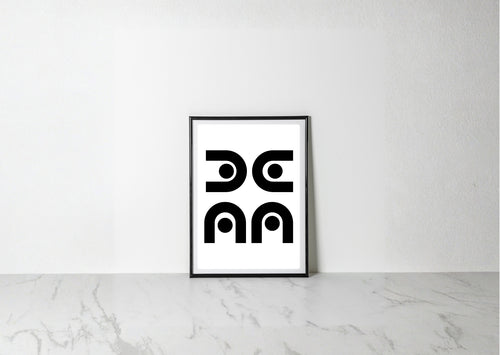 A minimalist black and white art print with a thin black frame, leaning against a white wall on a light gray marble surface.