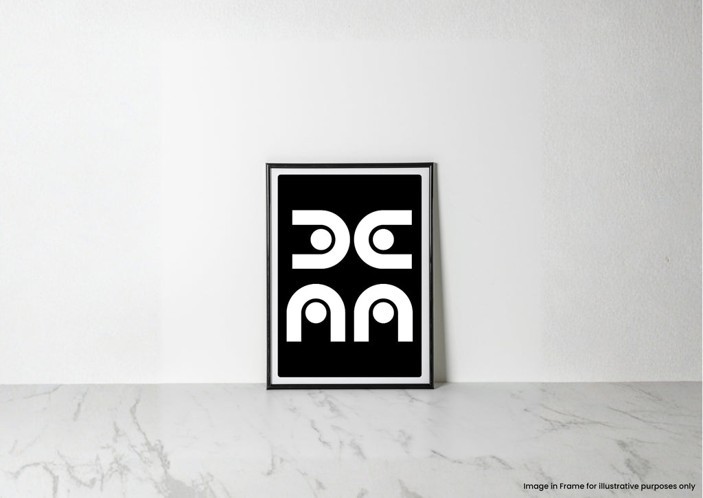 A minimalist black and white framed art print with a geometric design, leaning against a white wall on a light marble surface.