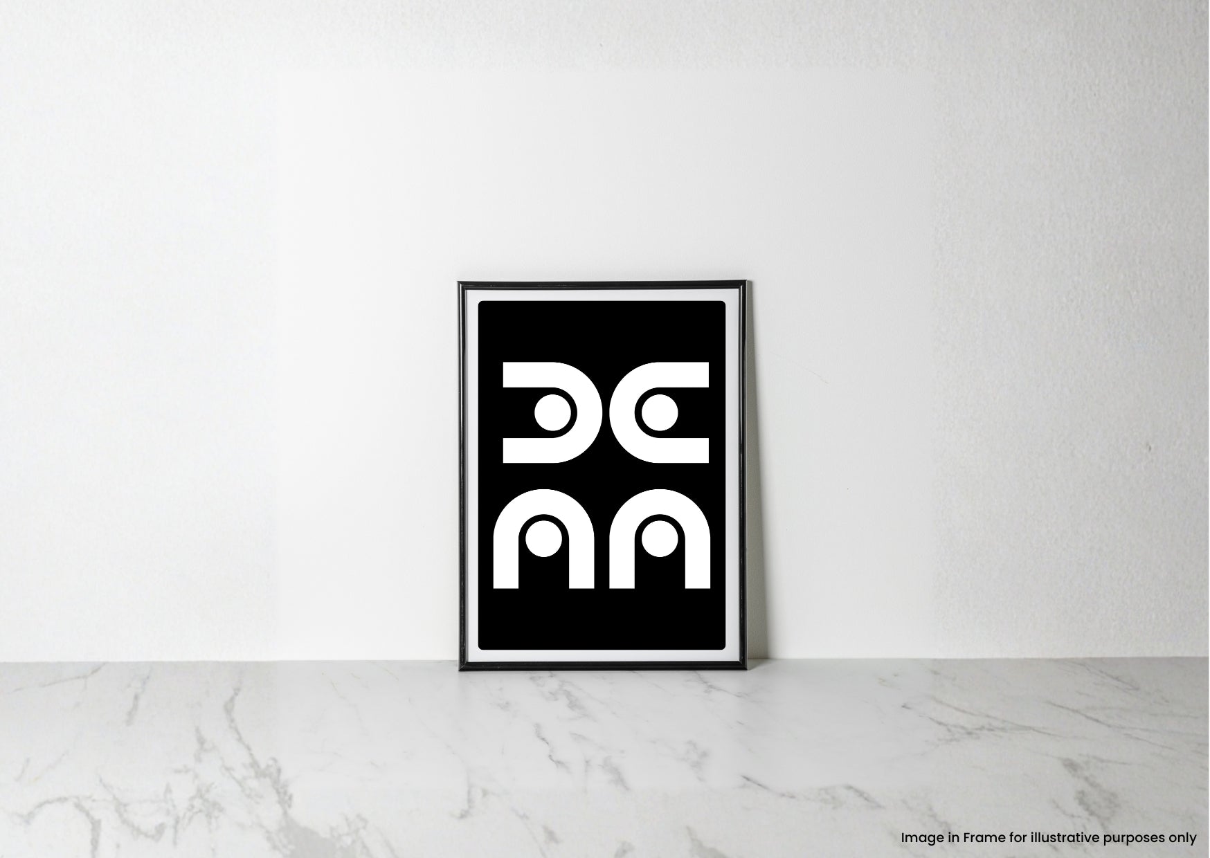 A minimalist black and white framed art print with a geometric design, leaning against a white wall on a light marble surface.