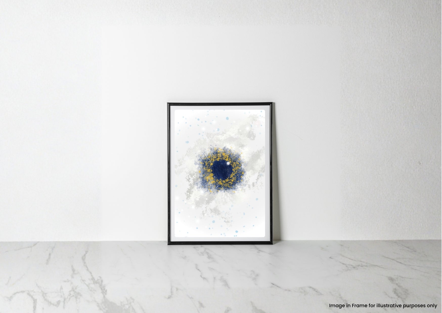 A framed abstract art print with a black frame, featuring a deep blue circular center and a textured gold ring on a white background, leaning against a white wall on a light marble surface.