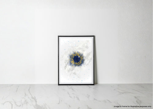 A framed abstract art print with a black frame, featuring a deep blue circular center and a textured gold ring on a white background, leaning against a white wall on a light marble surface.