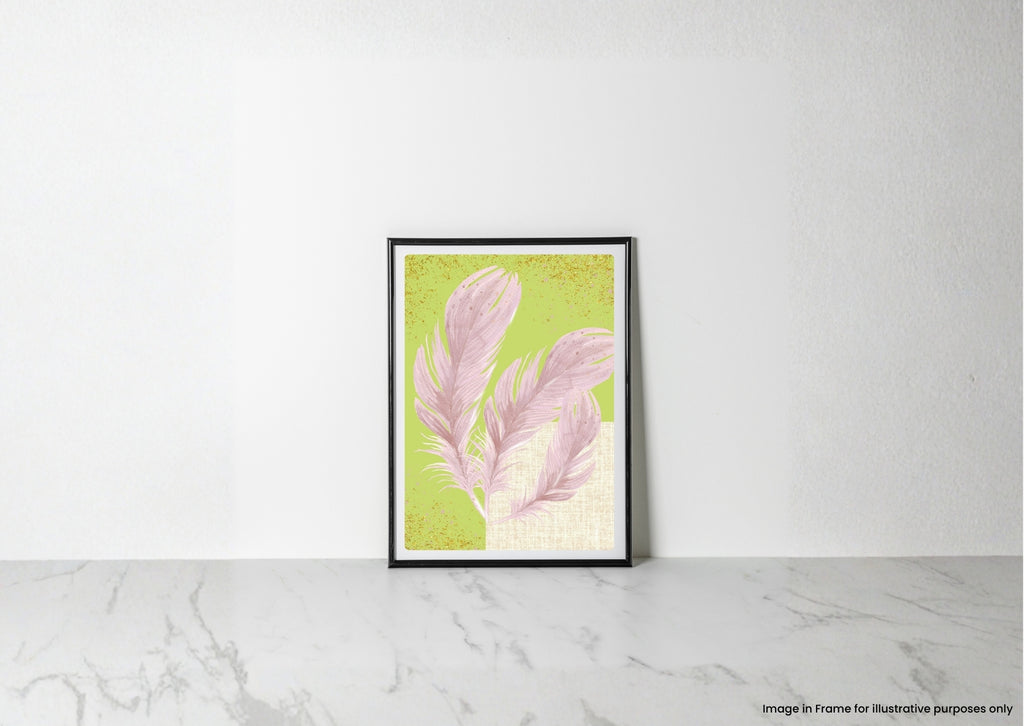 A framed art print featuring pink feathers on a textured light green background, leaning against a white wall on a light gray marble surface.