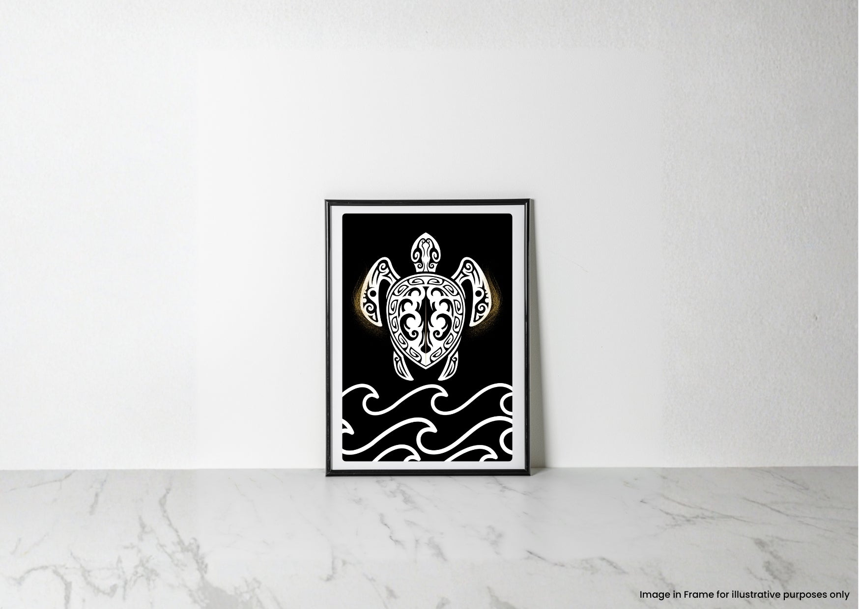 A framed black and white art print featuring a Polynesian-style turtle illustration with gold accents, leaning against a white wall on a light marble surface.