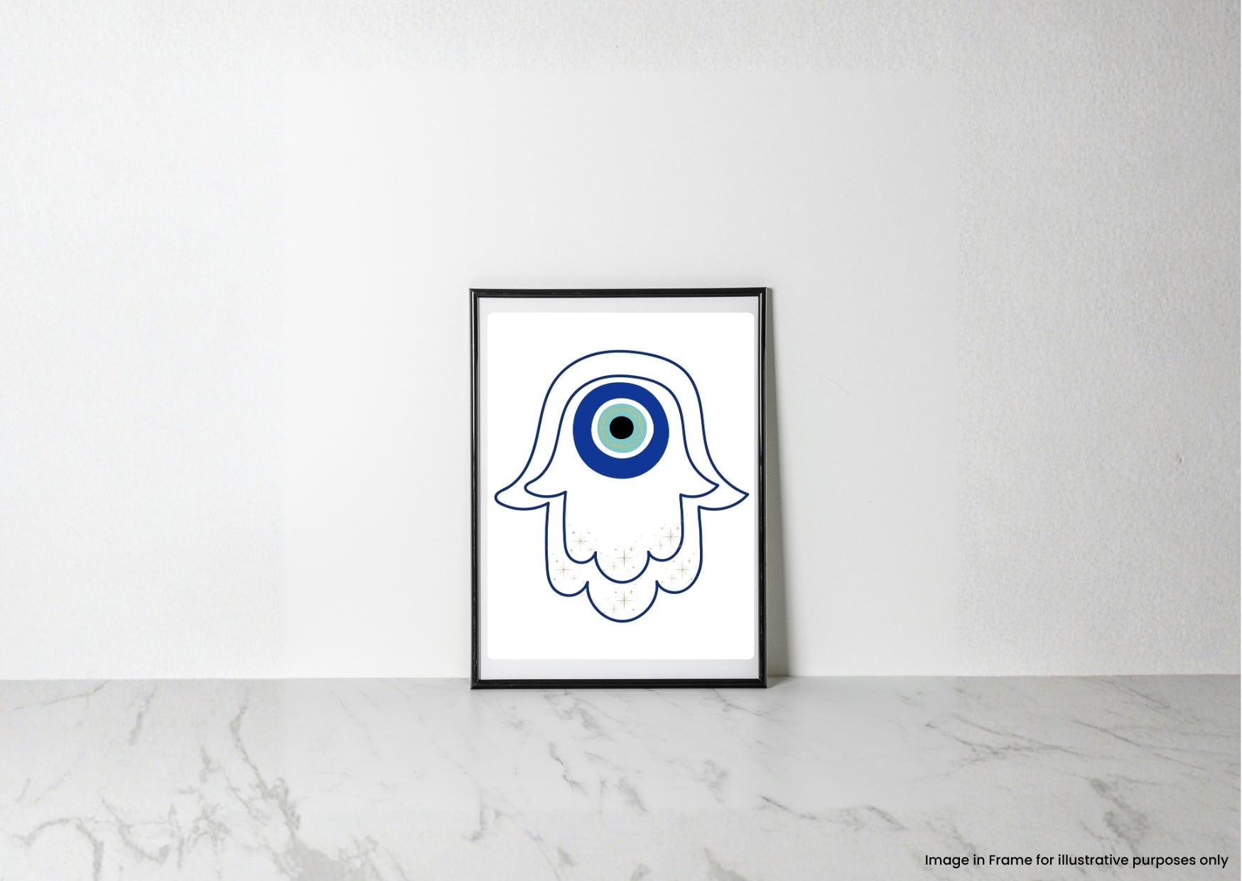 A framed art print featuring a white hamsa hand outline with a blue and green evil eye design, leaning against a white wall on a light marble surface.