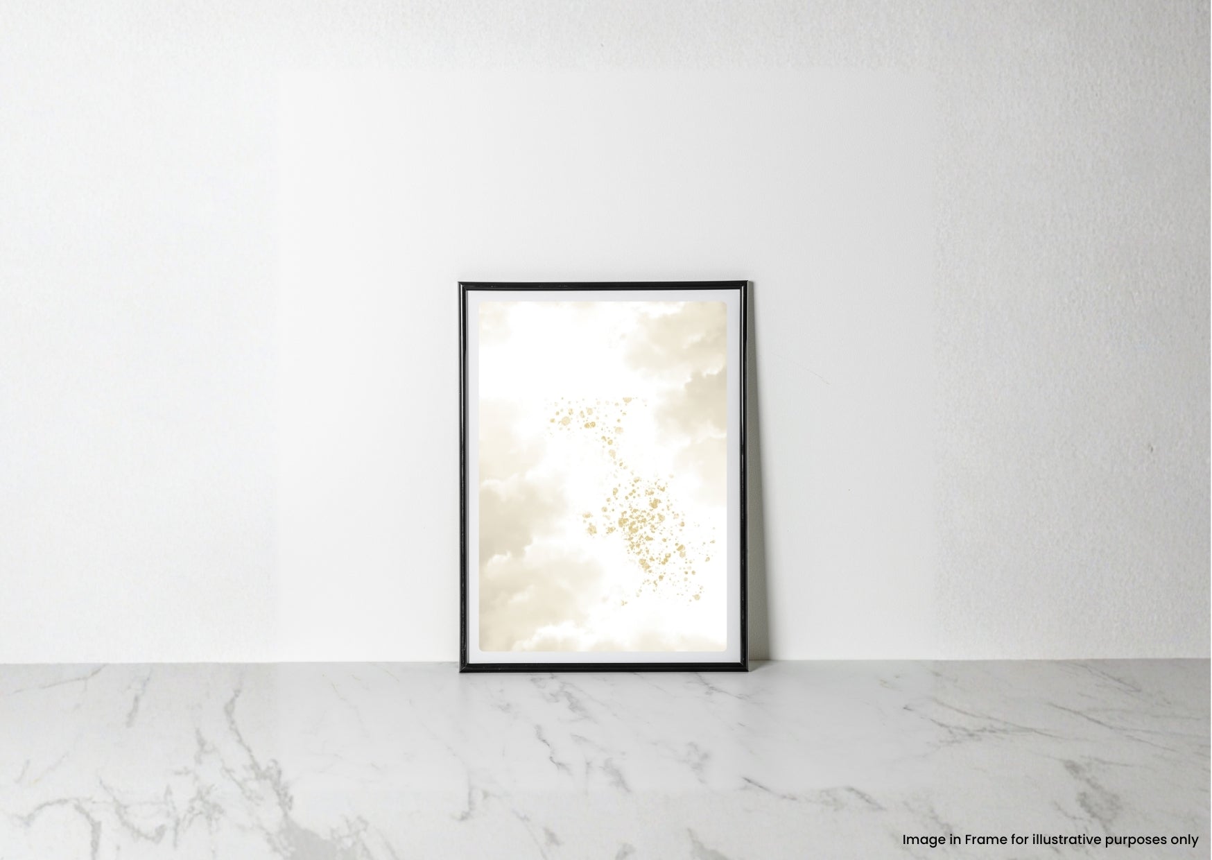 A vertical black-framed art print leaning against a white textured wall on a light marble surface. The print features an abstract design of cream, beige, and soft gold cloud-like forms.