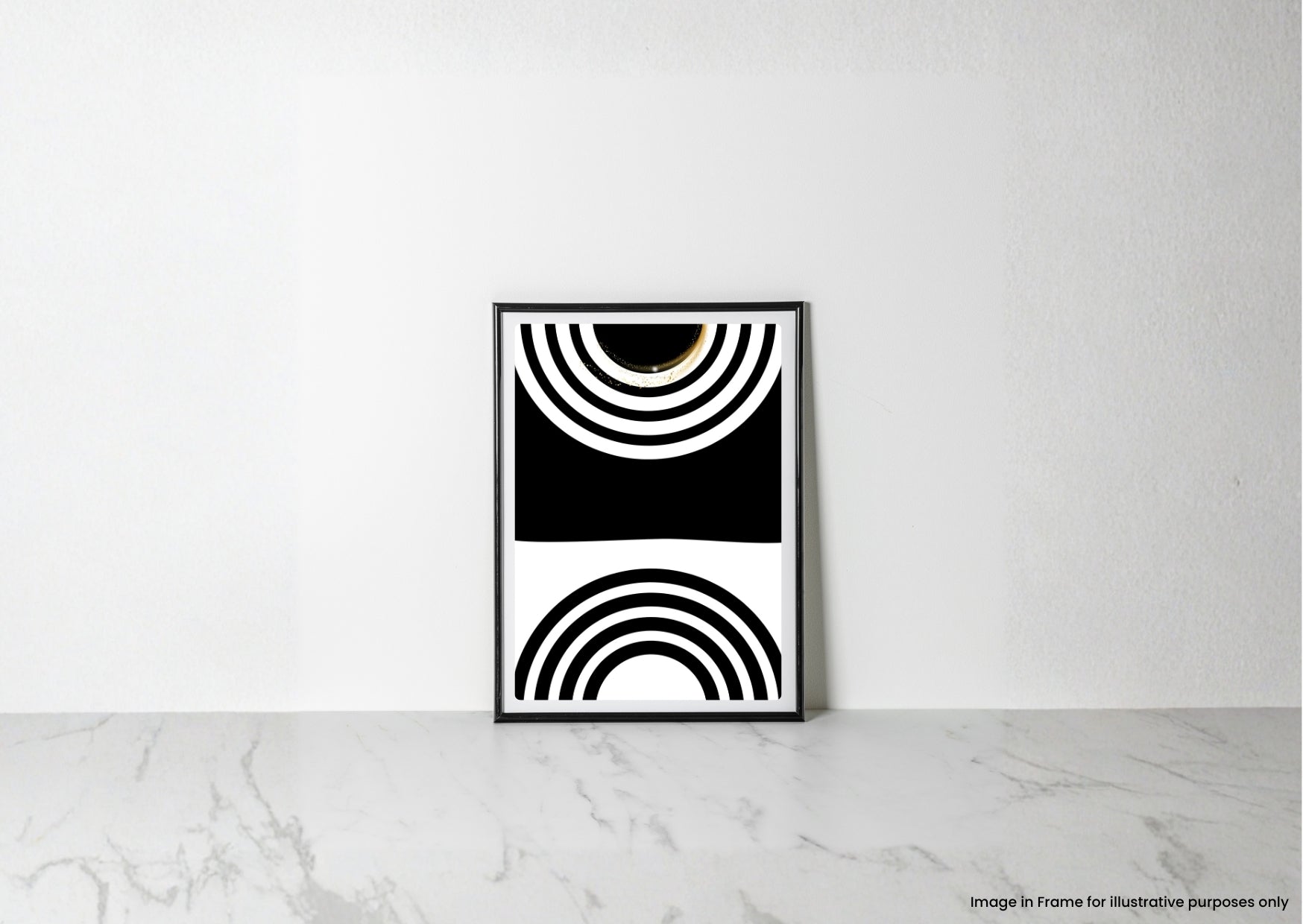 A framed black and white geometric art print with concentric arch patterns, leaning against a white wall on a light marble surface.