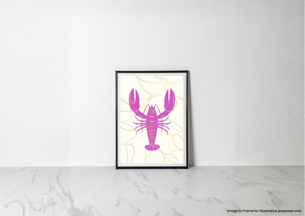 A framed lobster art print with a bright pink lobster silhouette on a cream background with thin yellow lines, leaning against a white wall on a light marble surface.