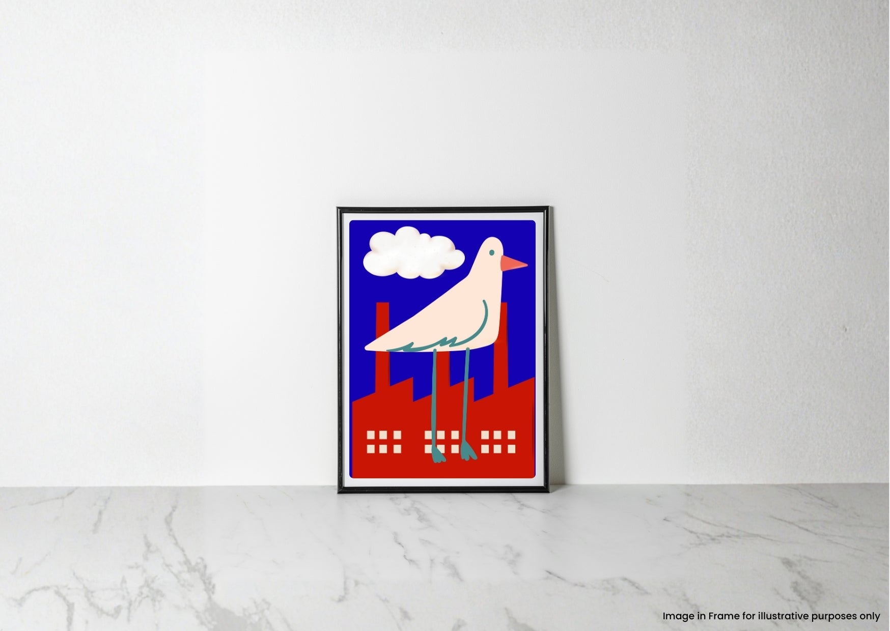 A framed art print featuring a stylized white bird with a pink beak standing on red factory chimneys under a blue sky with a white cloud, leaning against a white wall on a light marble surface.