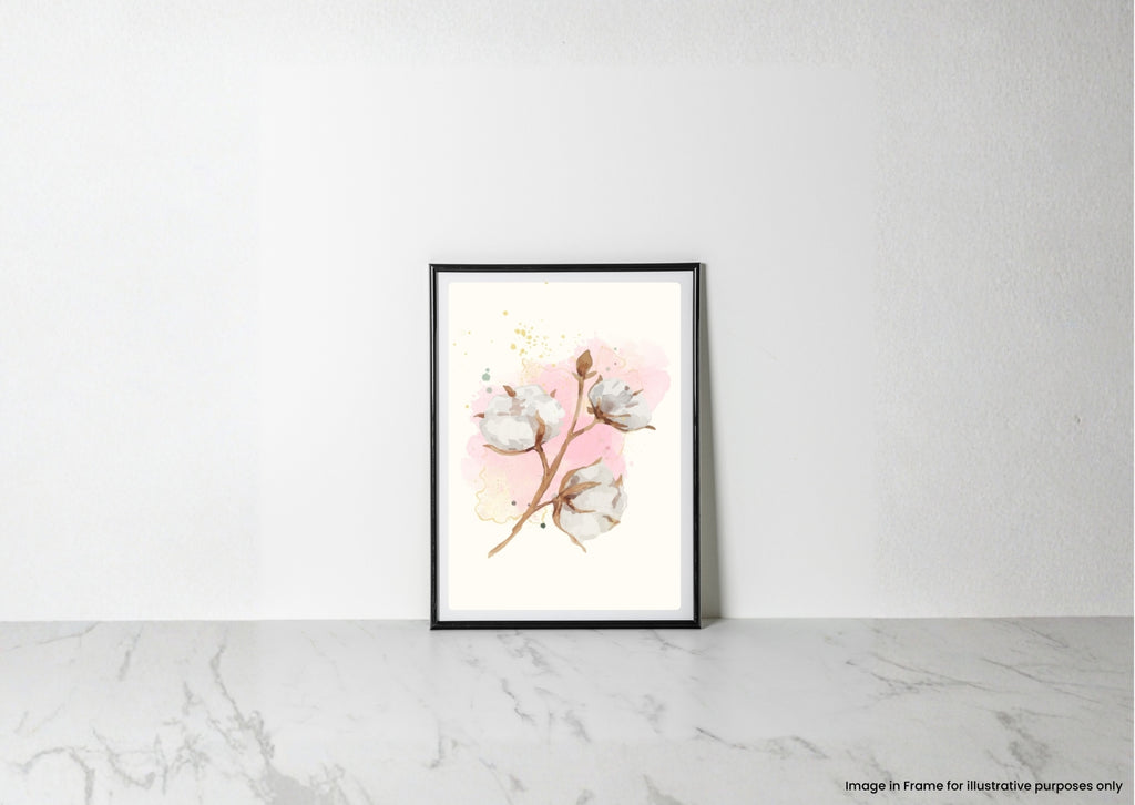 A framed botanical art print featuring cotton bolls on a soft pink watercolor background, leaning against a white wall on a light marble surface.