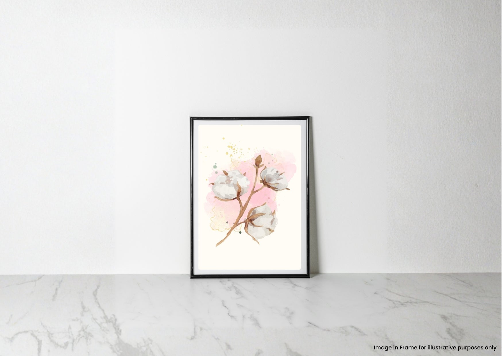 A framed botanical art print featuring cotton bolls on a soft pink watercolor background, leaning against a white wall on a light marble surface.