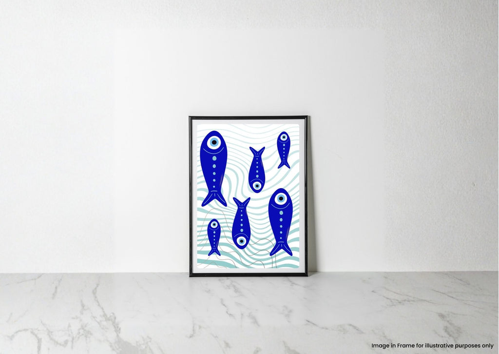 A framed art print featuring blue stylized fish on a white background with light blue wave patterns, leaning against a white wall on a light marble surface.