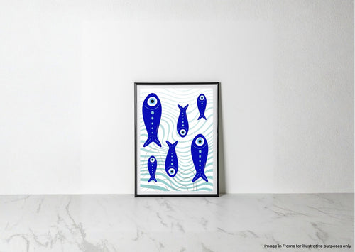 A framed art print featuring blue stylized fish on a white background with light blue wave patterns, leaning against a white wall on a light marble surface.