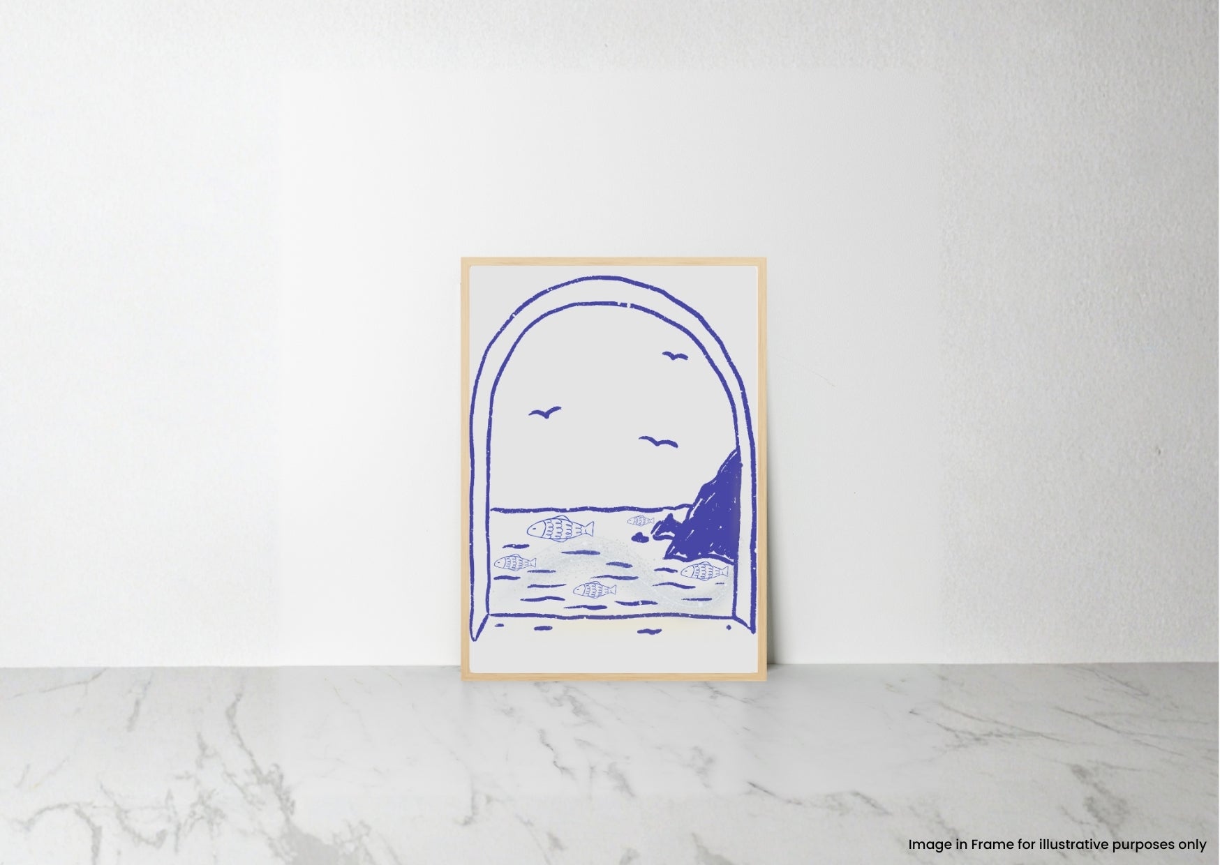 A minimalist art print featuring a blue line drawing of a coastal archway scene, displayed in a light wood frame on a white wall above a marble surface.