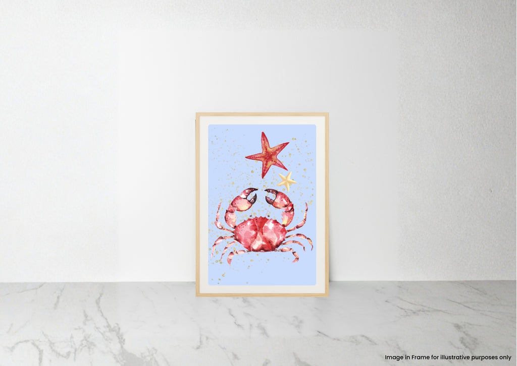 A framed art print featuring a watercolor-style red crab and red starfish on a light blue background, leaning against a white wall on a light marble surface.
