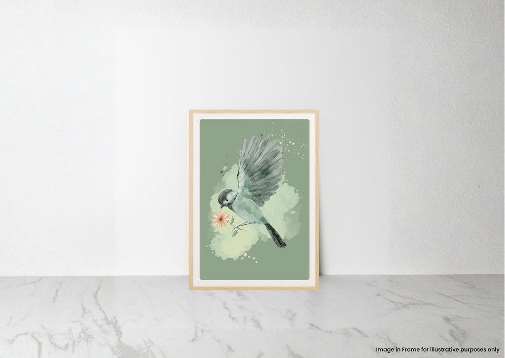 A framed art print featuring a watercolor bird perched on a branch with a small pink flower, displayed against a white wall on a light marble surface.