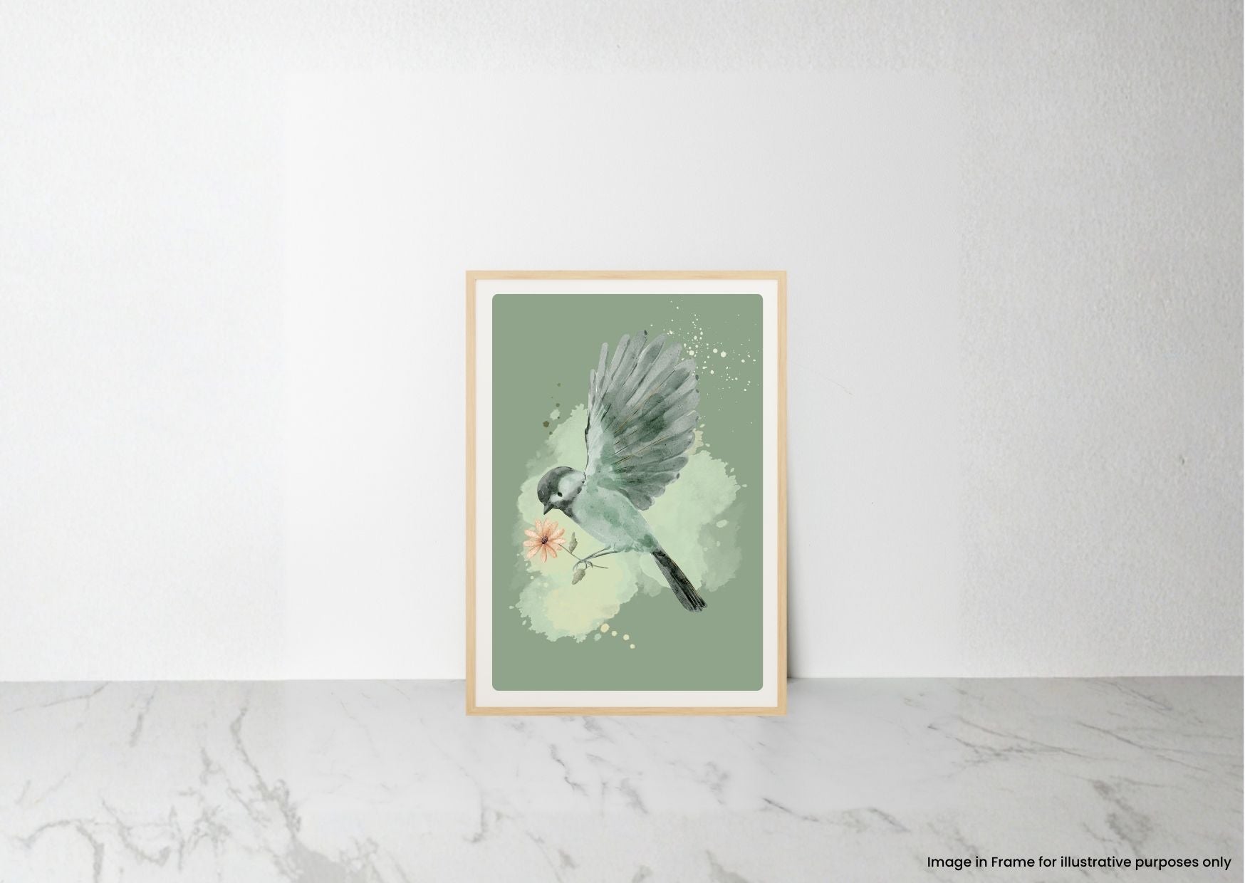 A framed art print featuring a watercolor bird perched on a branch with a small pink flower, displayed against a white wall on a light marble surface.