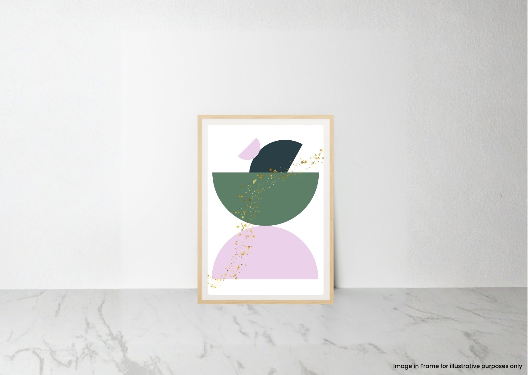 A framed abstract art print featuring geometric shapes in sage green, lavender, and black with delicate gold leaf accents, leaning against a white wall on a light gray marble surface.