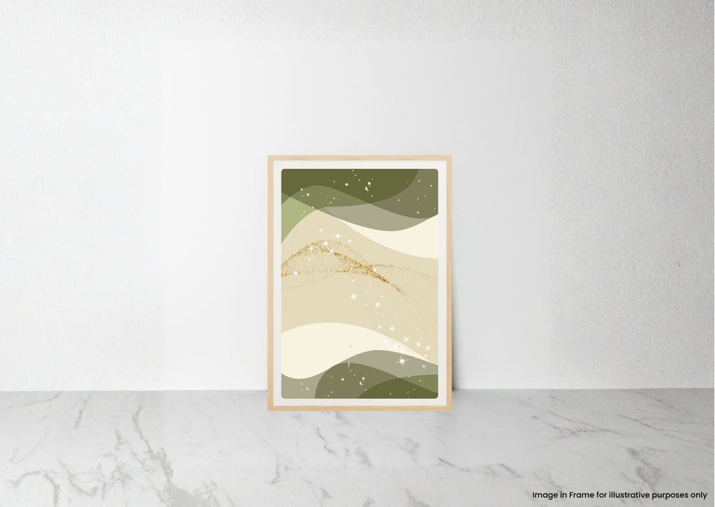 A framed abstract art print with wavy green, beige, and cream shapes and small gold accents, leaning against a white wall on a light marble surface.