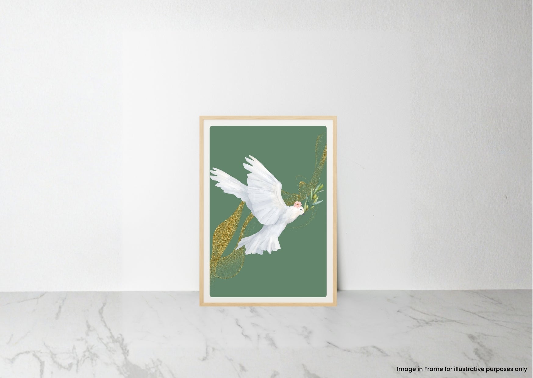 A framed art print featuring a white dove carrying an olive branch against a muted green background, leaning against a white wall on a light marble surface.
