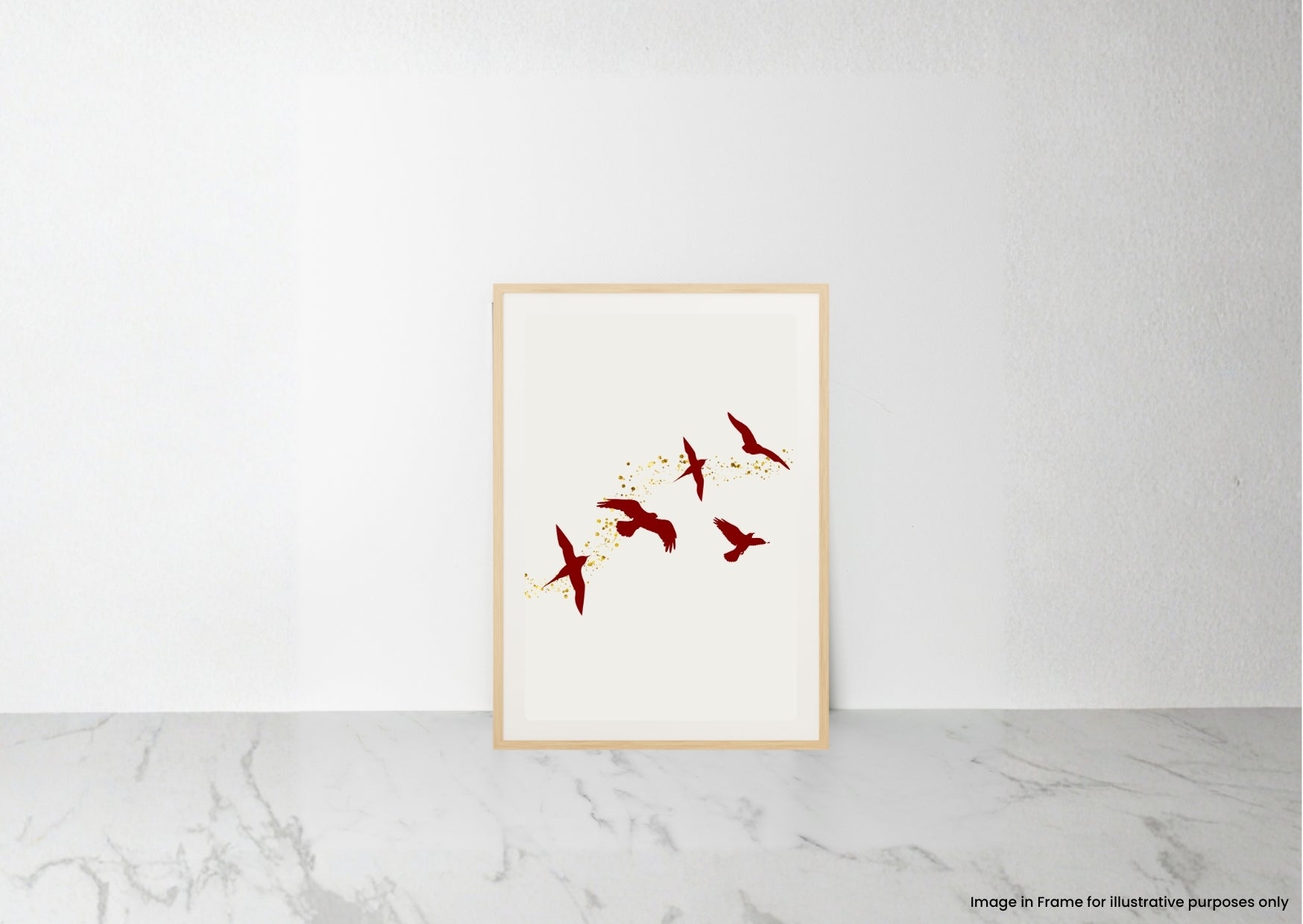 A minimalist framed art print featuring red birds flying over yellow flowers on an off-white background, styled leaning against a white wall on a light gray marble surface.