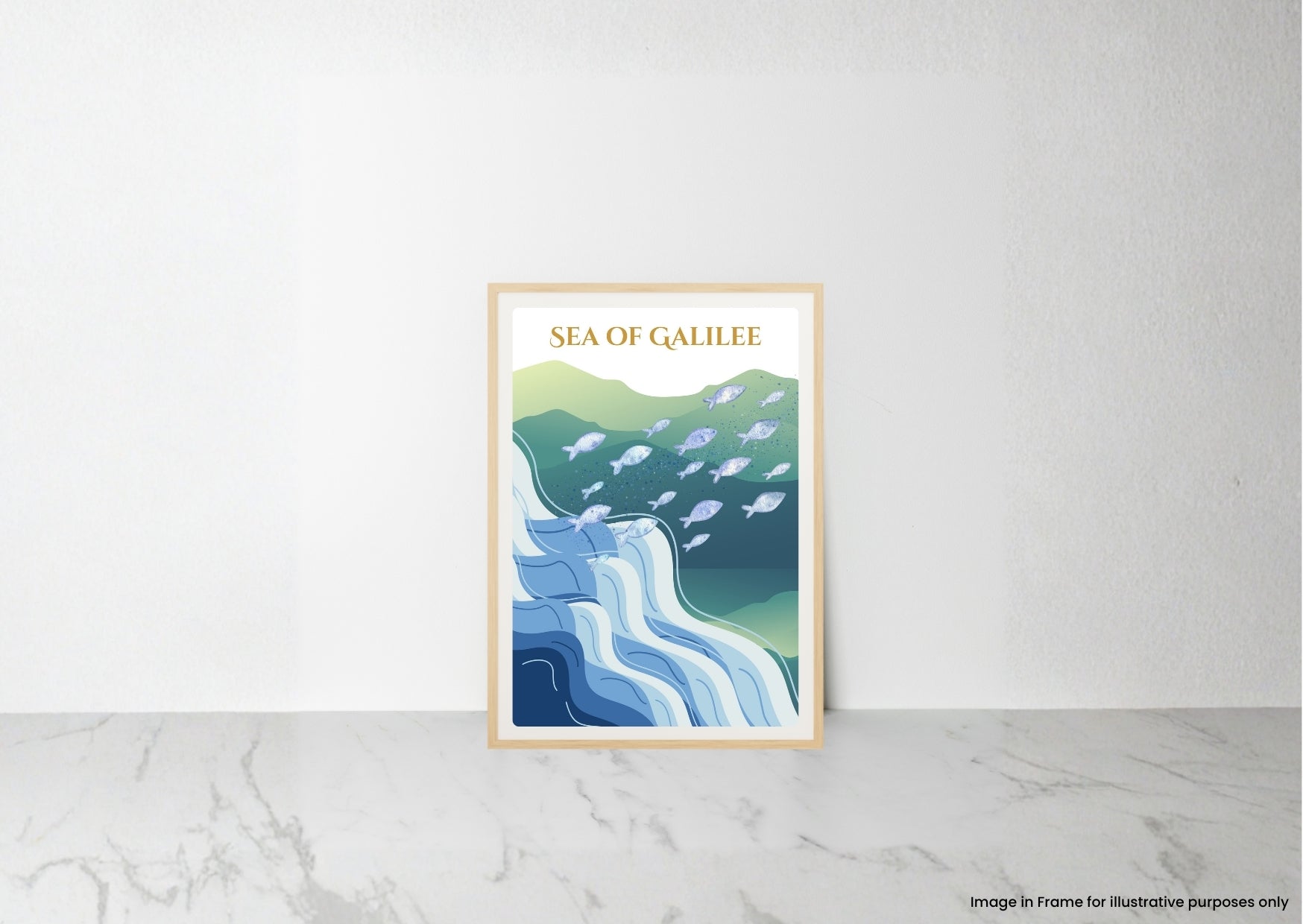 A framed art print titled 'SEA OF GALILEE' leaning against a white wall on a light marble surface. The print features a stylized illustration of blue and green waves with white fish, enclosed in a light wood frame.