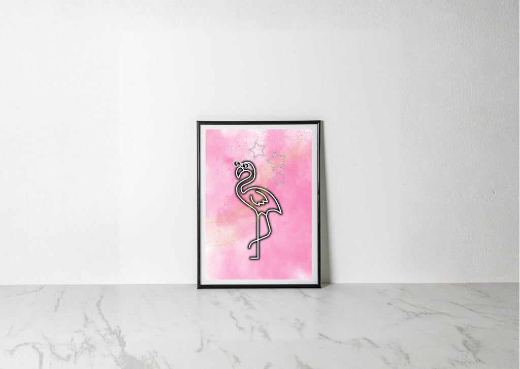A framed art print featuring a minimalist black line drawing of a flamingo on a pink watercolor background, leaning against a white wall on a light marble surface.