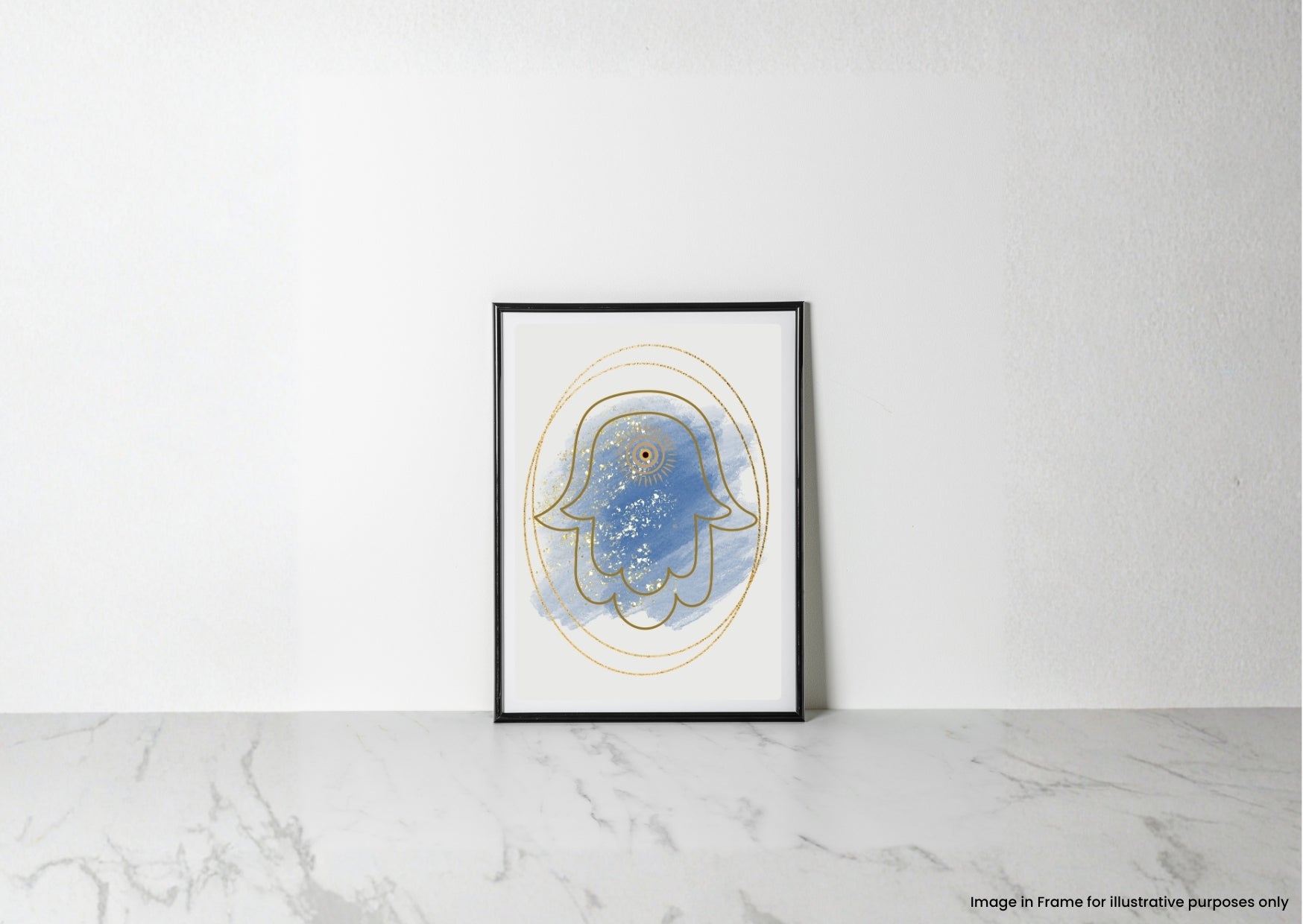 A framed abstract art print featuring a blue Hamsa hand with gold line details, leaning against a white wall on a light marble surface.
