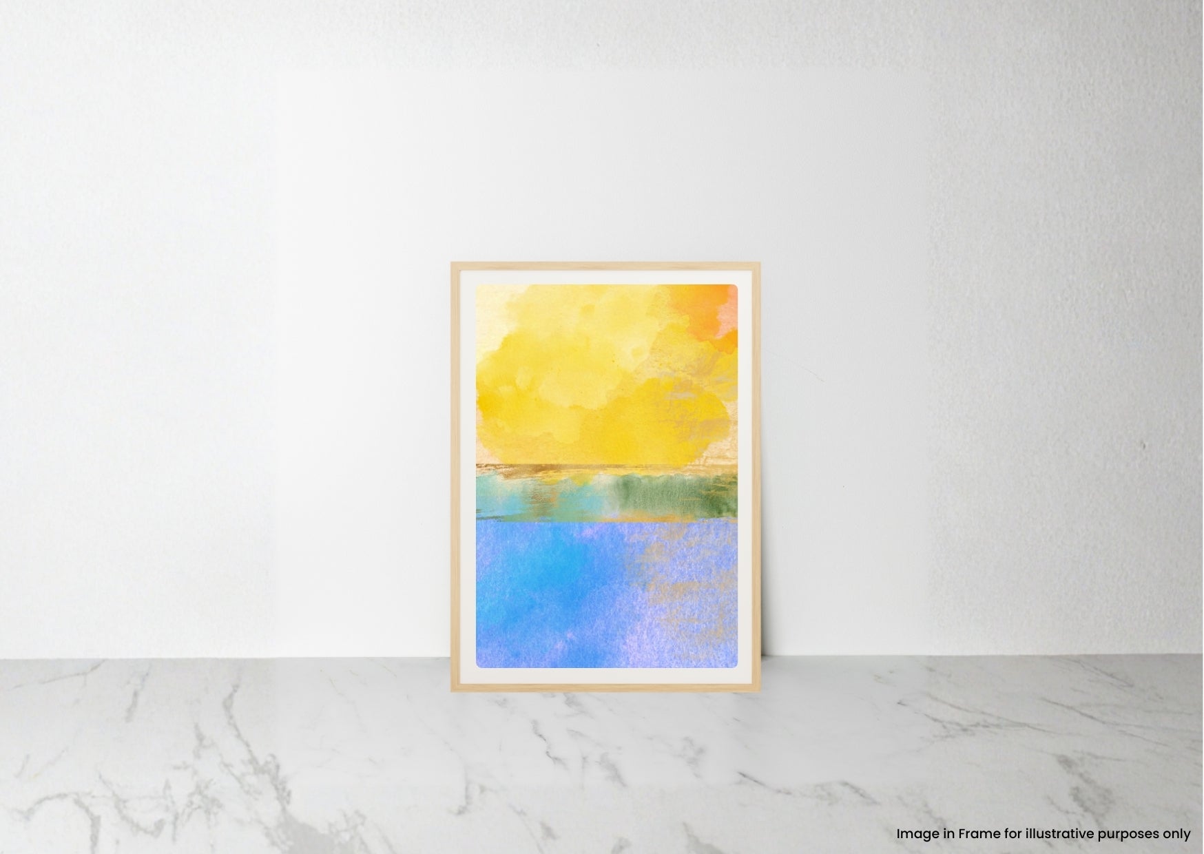 A framed abstract art print featuring a yellow and orange sky above a blue water landscape, leaning against a white wall on a light marble surface.