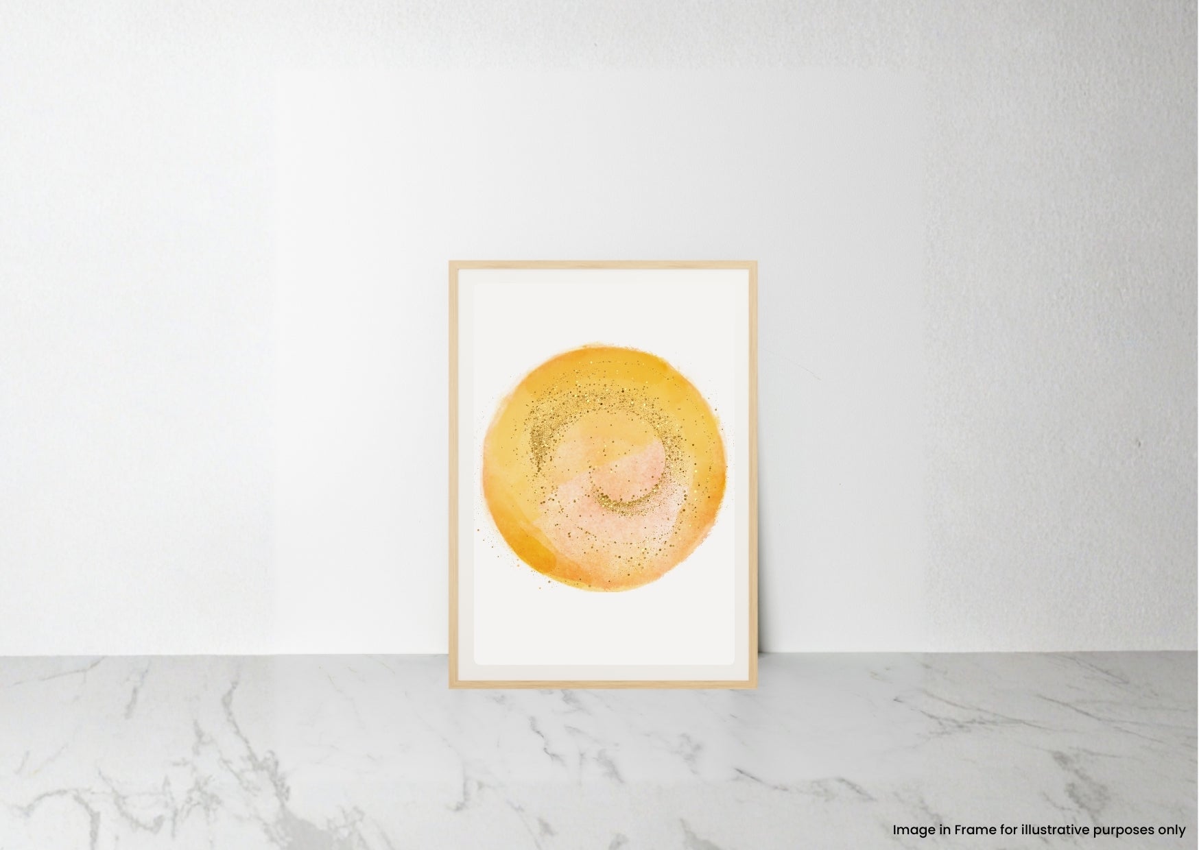 A minimalist framed art print featuring a textured yellow and orange circular watercolor design on a white background, leaning against a white wall on a light gray marble surface.