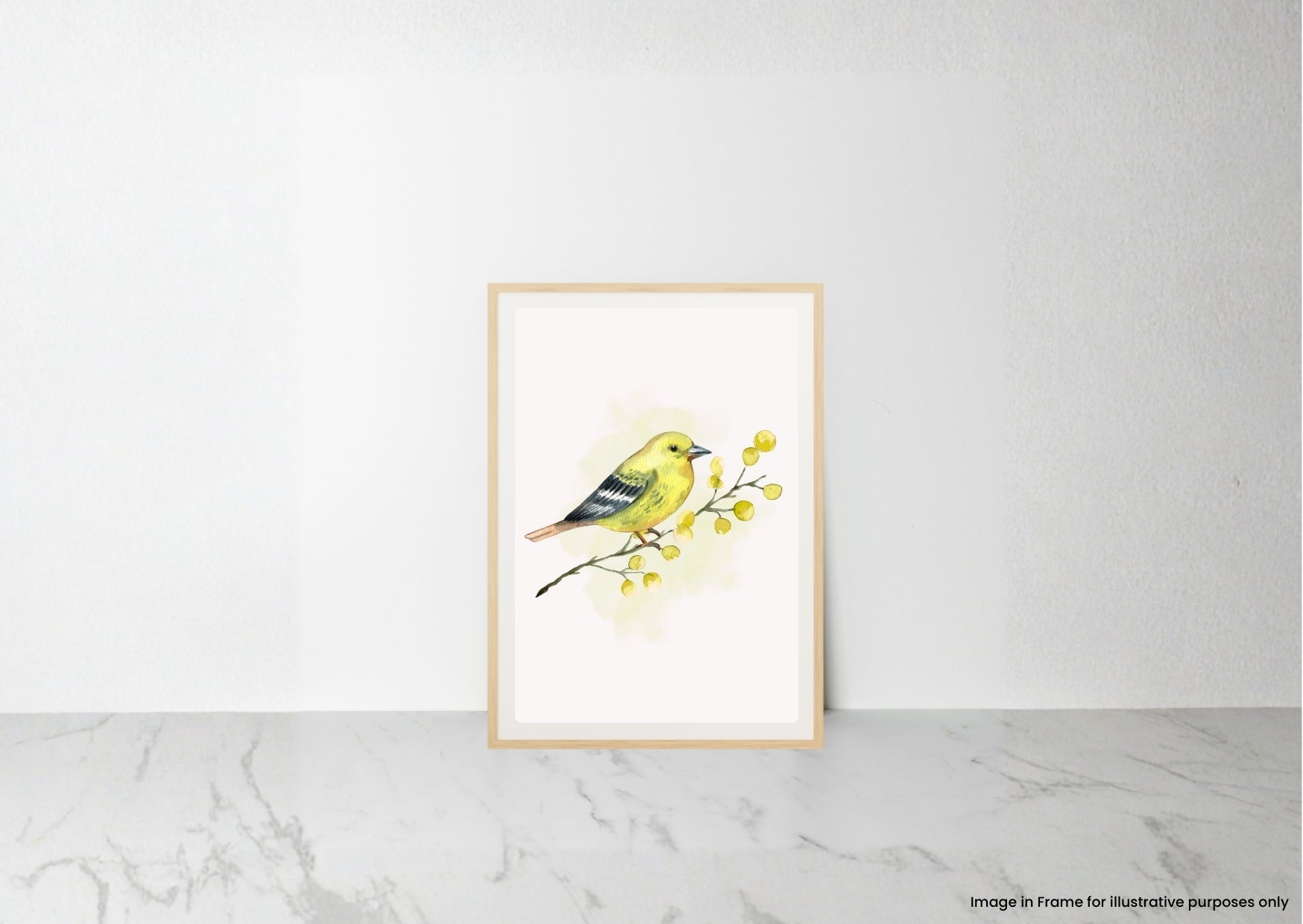 A framed watercolor art print of a yellow bird perched on a branch with small yellow flowers, leaning against a white wall on a light marble surface.