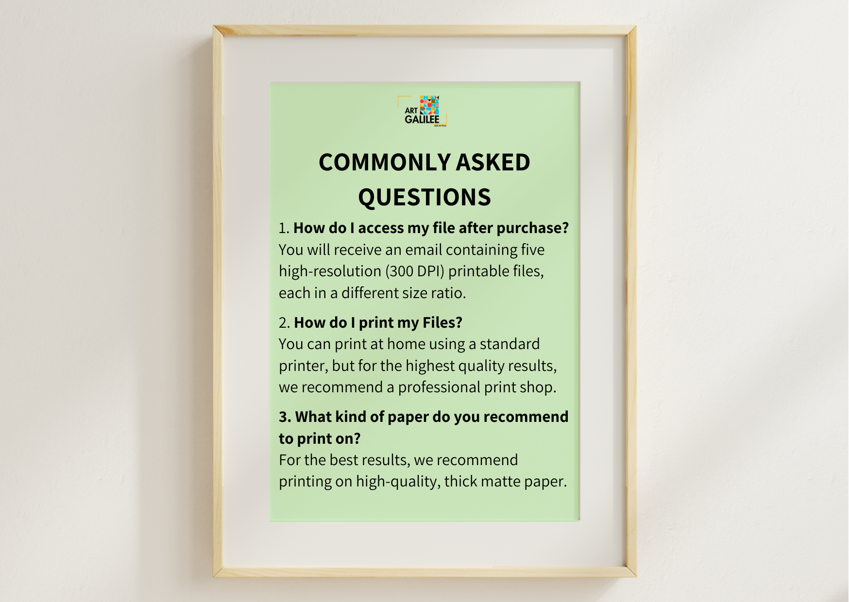 A framed informational poster titled 'COMMONLY ASKED QUESTIONS' with text about accessing and printing files, displayed against a light wall.