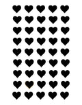 A sheet of small black heart-shaped stickers arranged in a grid on a white background, with one heart at the bottom center shown in a close-up view.